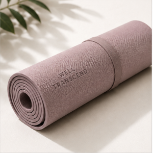 Soft mauve non-slip yoga mat with carrying strap for Pilates, stretching, and home workouts.
